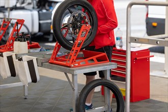 A Man Repairing a Tire of sportive motorbike