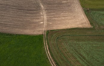 Drone view of green and ploughed fields with field path near Pabneukirchen