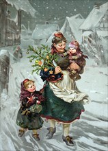 Woman with two children and a small decorated Christmas tree and presents walks through the village in the snow
