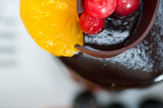 Chocolate cake and fresh fruit on top closeup macro