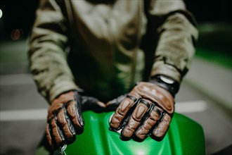 A motorcyclist shows his leather brown gloves for a touring trip to the camera