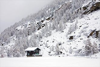 Wooden chalet in the snow in winter in the Gran Paradiso National Park