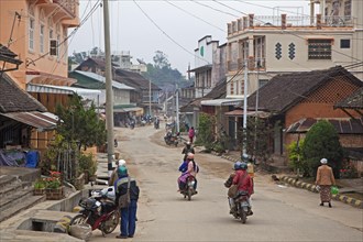 Motorcycles riding through the town Keng Tung