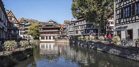 Half-timbered houses and restaurants along the River Ill in the Petite France quarter of the city Strasbourg
