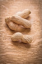 Four peanuts on vintage wooden board Food and drink concept