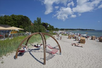 Sunbathers in hammocks and beach chairs at the seaside resort Haffkrug