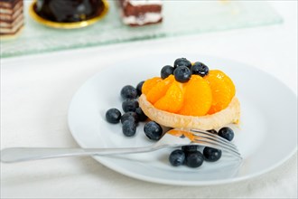 Fresh blueberry and tangerine orange cream cupcake homemade closeup macro