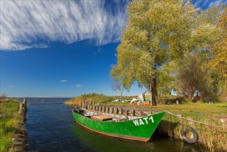 Fishing boat in small harbour of the Achterwasser at Warthe near Rankwitz on Usedom island in the Baltic Sea