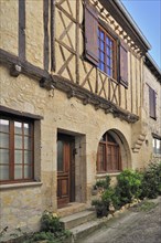 Old facade of historic house at La Romieu