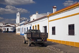 Cobbled high street with white houses in Castro Verde