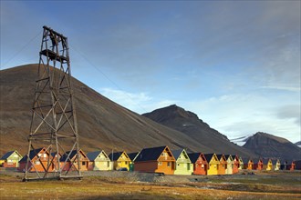 Cableway from abandoned coal mine and colourful wooden houses in the settlement Longyearbyen in summer