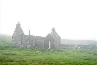 Abandoned crofter's house in thick mist