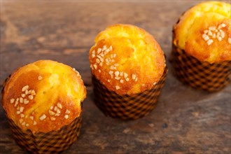 Fresh baked muffin on old wood table