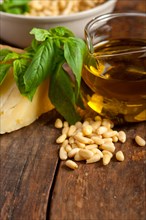 Italian basil pesto ingredients over old wood macro