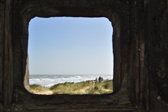 View over the sea through loophole in bunker at Utah Beach