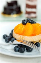 Fresh blueberry and tangerine orange cream cupcake homemade closeup macro