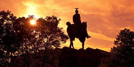 Equestrian statue of Kaiser Wilhelm II backlit at sunset