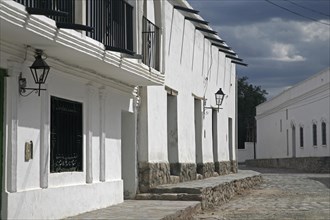 Typical white houses in street at Cachi