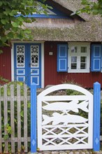 Decorated entrance door of idyllic thatched cottage in the village Born auf dem Darss