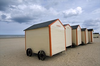 Row of colourful beach cabins on wheels along the North Sea coast at De Panne