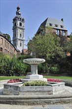 Fountain in park and belfry at Mons
