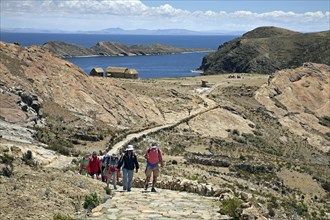 Tourists hiking on the island Isla del Sol in Lake Titicaca