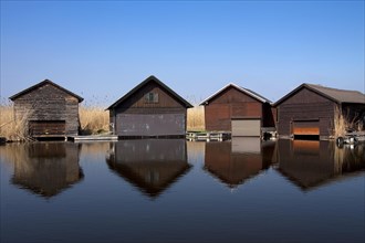 Wooden boat houses along Lake Neusiedel at Rust