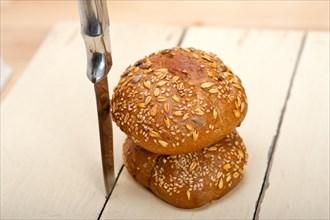 Fresh organic bread over rustic table macro closeup