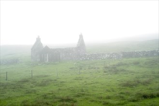 Abandoned crofter's house in thick mist