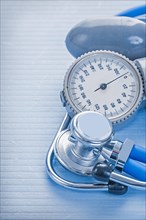 Blood pressure monitor and stethoscope on a blue background
