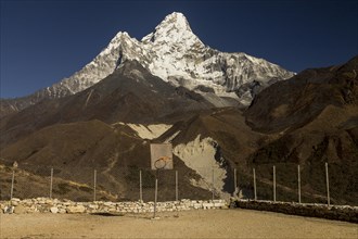 High altitude backboard and basketball court with six-thousander Ama Dablam in the background. Pangboche Human School built by Um Hong Gil Human Foundation. Upper part of Pangboche