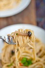 Italian pasta and mushroom sauce over rustic old wood