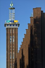 Trade fair tower with RTL logo and Hermes faces by Hans Wissel