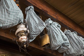 Hams wrapped in cloth for further aging and stored by hanging from the ceiling in farmhouse