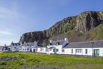 Row of white houses in former slate-mining village Ellenabeich on the isle of Seil