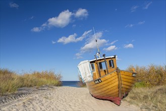 Traditional wooden fishing boat in the dunes along the Baltic Sea at Ahlbeck