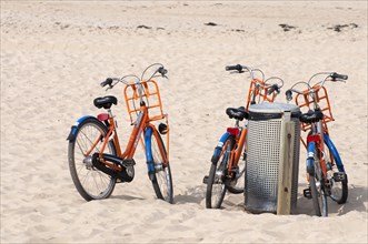 Bicycles near dustbin on the beach