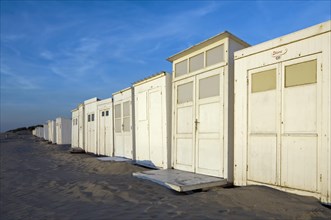 Row of white beach cabins along the North Sea coast at seaside resort Koksijde