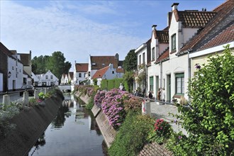 Typical white houses along the Lissewege canal at the little village Lissewege