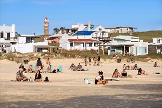 Tourists sunbathing on the beach at the hamlet Cabo Polonio along the Atlantic Ocean coast