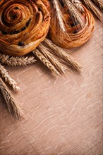 Bunches of golden wheat ears sultana bakery on oak board food and drink concept
