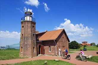 Cyclist in front of the lighthouse at the Cape of Vente