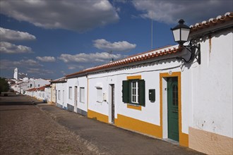 Cobbled street with white houses in Castro Verde