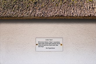 Sign on a thatched roof