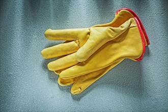 Leather safety gloves on concrete background construction concept