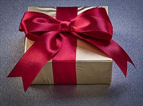 Boxed gift on grey background top view holidays concept