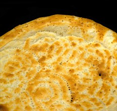 Original fresh uzbek bread isolated over black background