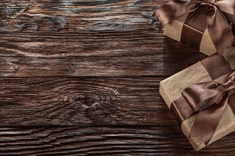 Brown gift boxes on vintage wooden board top view