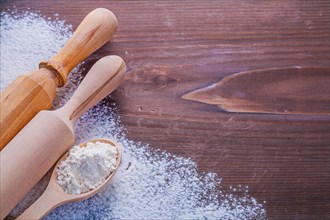 Copyspace image wooden spoon with white natural flour and rolling pin on vintage board horizontal version food and drink concept