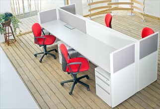 Office desks and red chairs cubicle set view from top over wood flooring